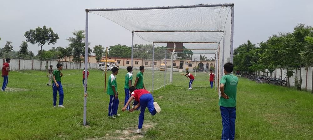 Students practising cricket in the school ground
